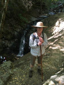 Author hiking next to waterfall